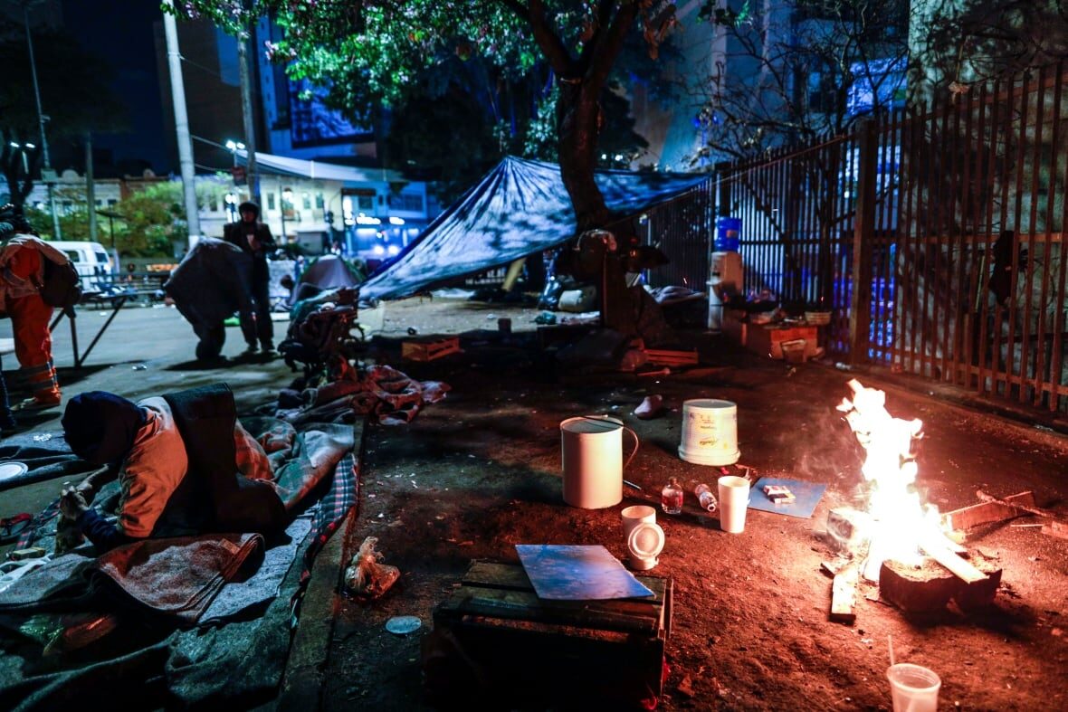 Click to enlarge Homeless people improvise a bonfire to try to keep warm during a cold night in Sao Paulo on Thursday. A fierce cold snap on Wednesday night prompted snowfall in southern Brazil, where such weather is rare.