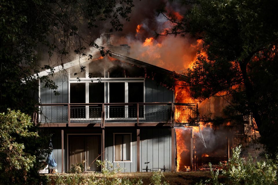 A home is consumed by flames in the River Fire,