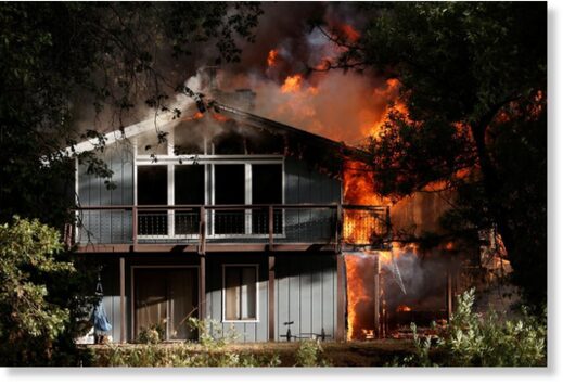 A home is consumed by flames in the River Fire,