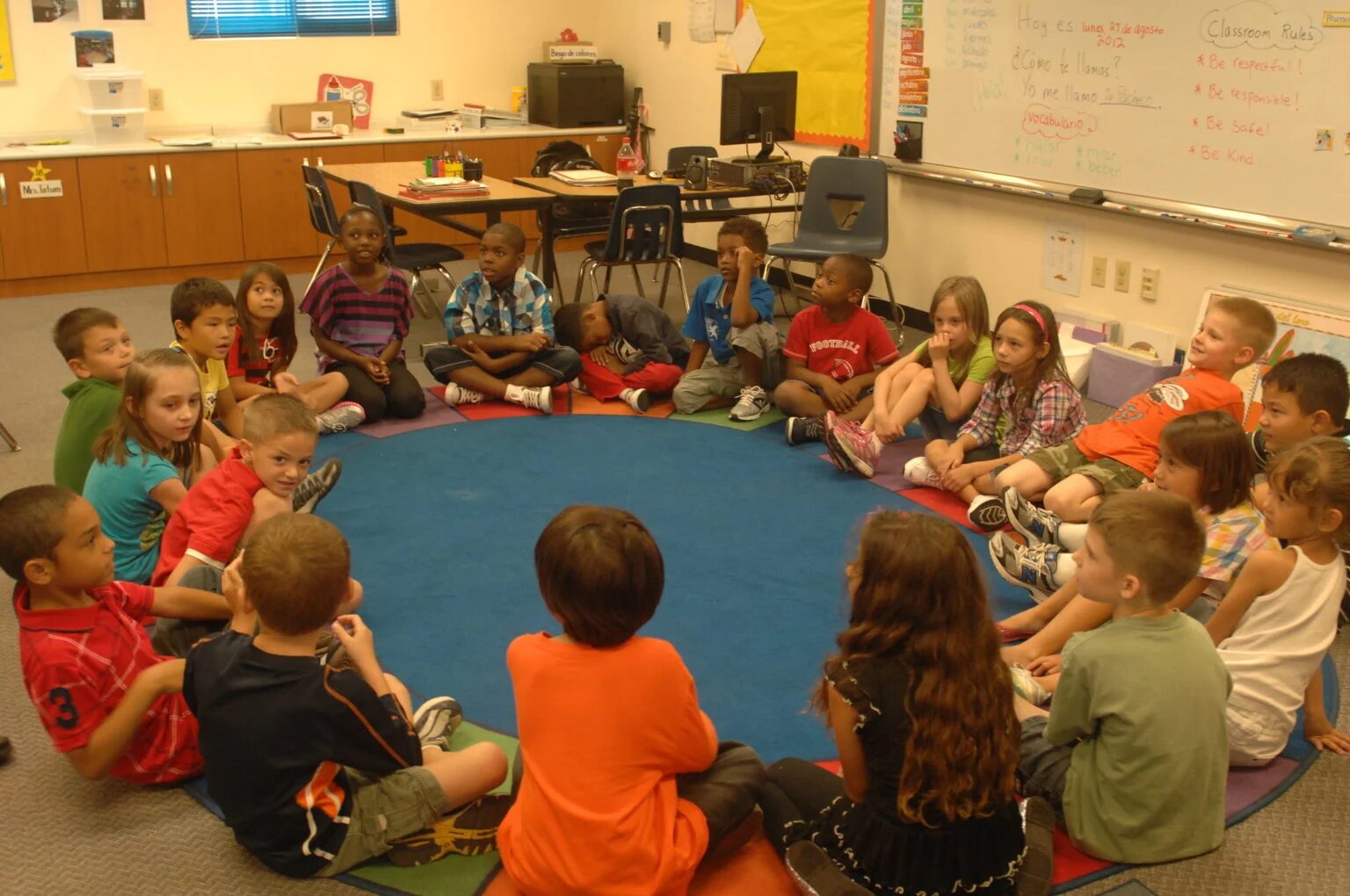 Click to enlarge school children sitting circle