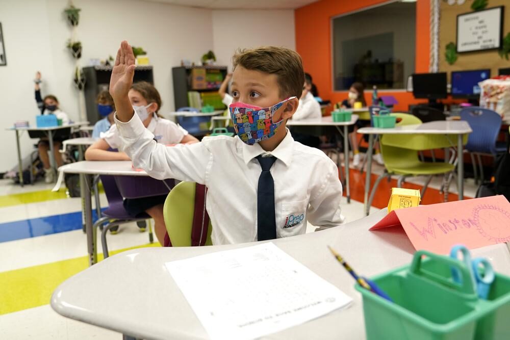 Student Winston Wallace, 9, raises his hand in class at iPrep Academy