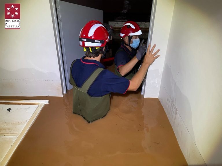 Firefighters help clear a flooded home in Benicàssim in Castellón Province, Spain, 29 August 2021.