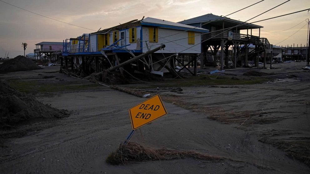 Sand and debris covers a road in a damaged neighborhood in the aftermath of Hurricane Ida