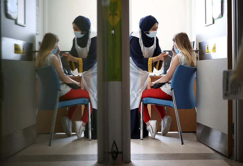Click to enlarge A woman receives vaccine.