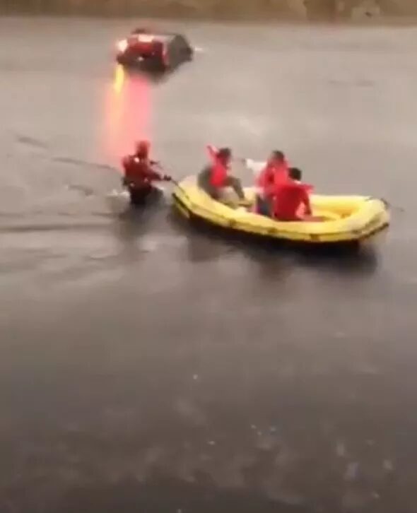 Click to enlarge Milan: Emergency services are seen rescuing the public