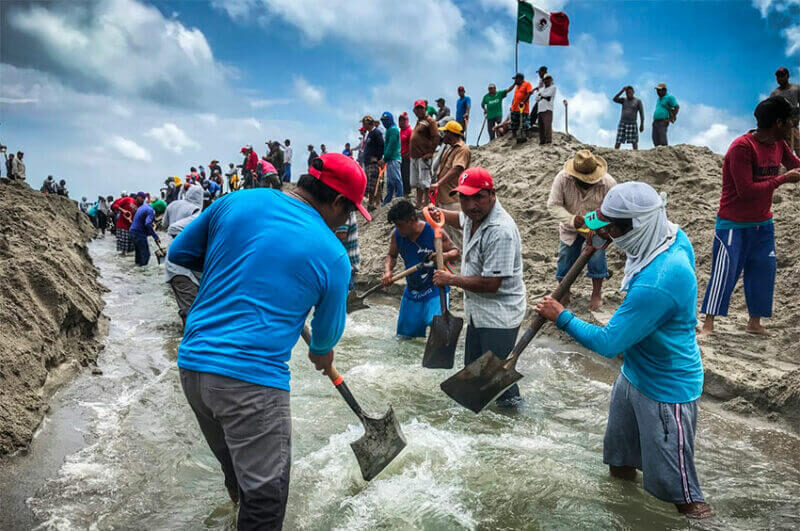 Residents of San Dionisio del Mar relieve flooding by opening a channel between a lagoon and the ocean.