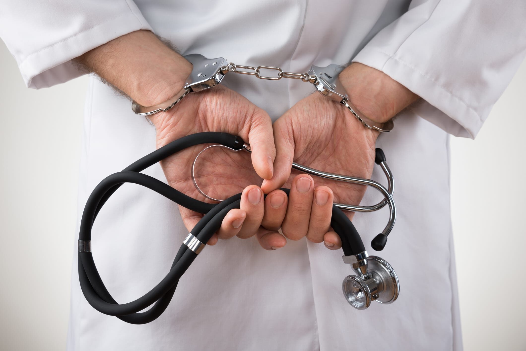 doctor in handcuffs