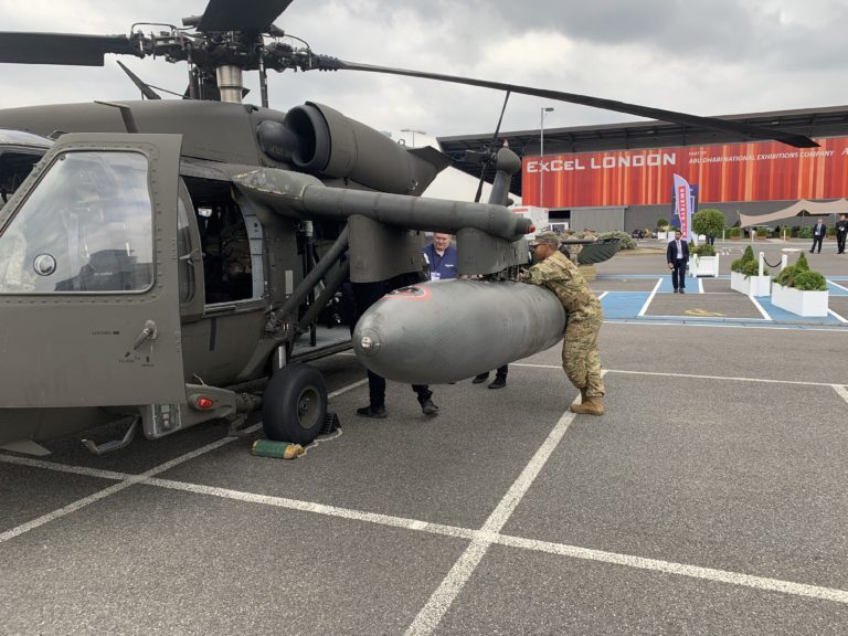 Click to enlarge A US soldier leans on a Black Hawk helicopter