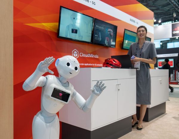 An AI robot (L) by CloudMinds is seen during the Mobile World Conference in Shanghai on June 27, 2018