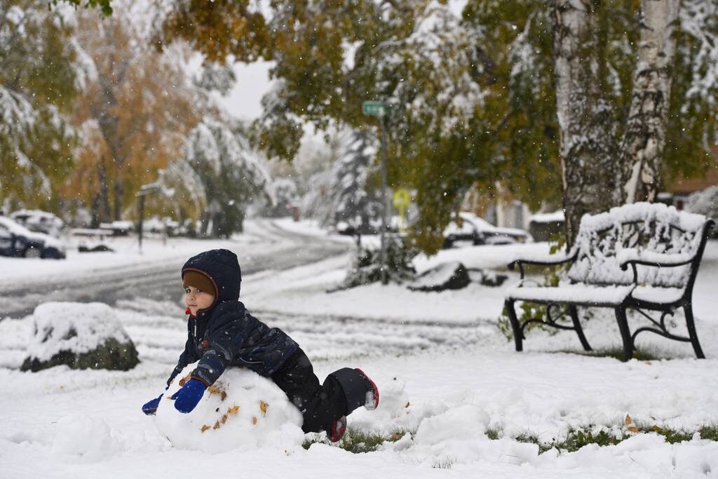 Two-year-old Ramiar Harki plays in the snow in his East Anchorage yard on September 24, 2021.