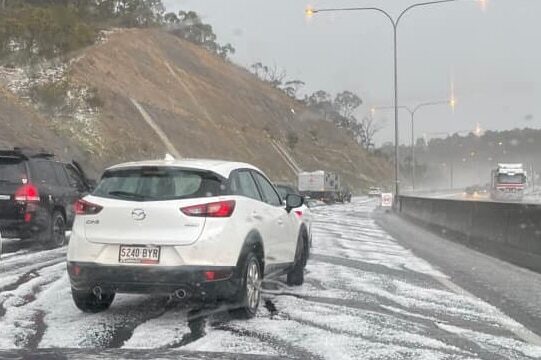 Cars drive carefully after heavy hail on South Eastern Freeway.