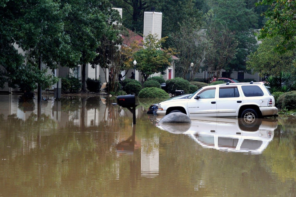 A flooded neighborhood is shown in Pelham, A