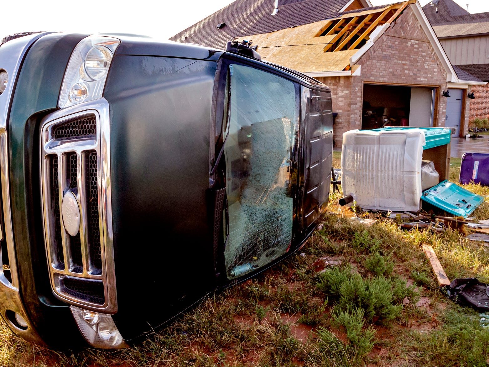 Storm damage to a home and an overturned truck caused by a tornado that hit in the early morning hours Wednesday near SW 49 and Czech Hall Road in Mustang.
