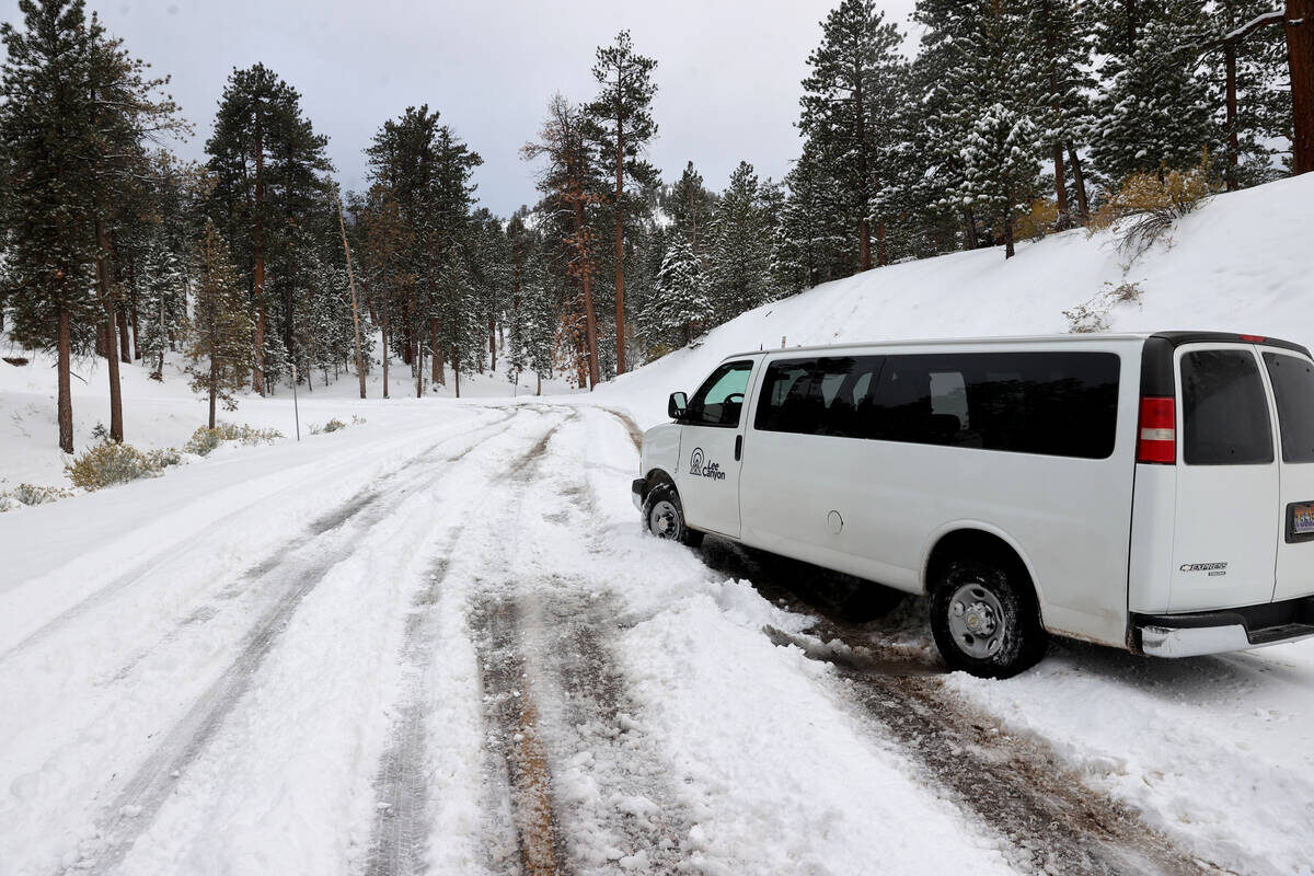 A shuttle van sits stuck in the snow at the Lee Ca