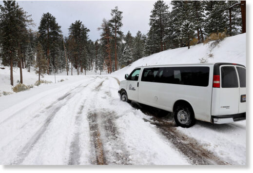 A shuttle van sits stuck in the snow at the Lee Ca
