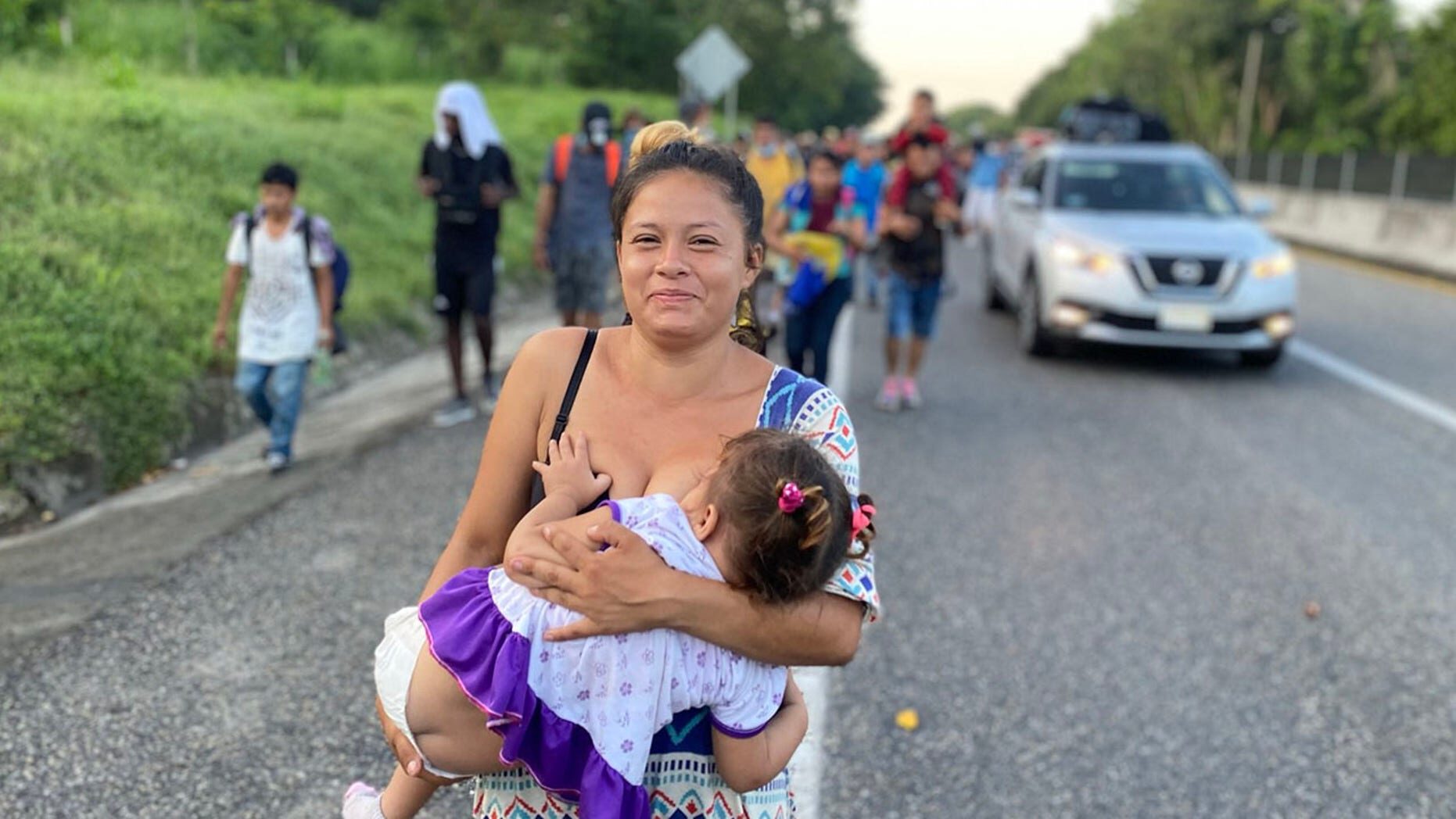 Click to enlarge A woman migrant breastfeeding