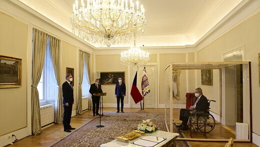 Czech president appoints PM from inside big glass box after testing positive for Covid