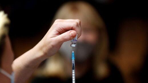 Click to enlarge nurse preps vaccine