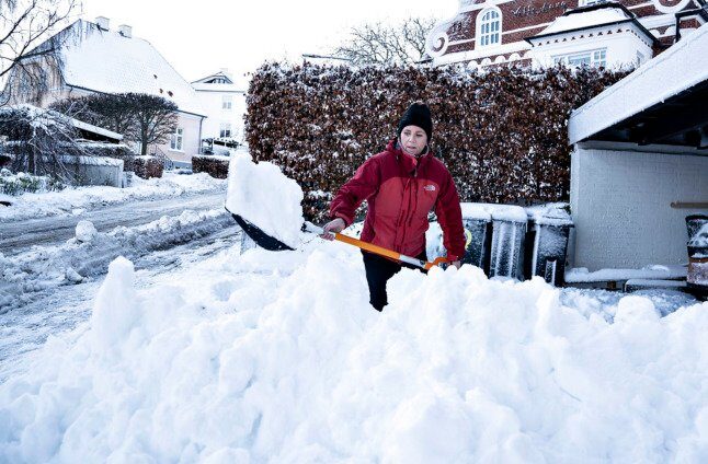 Click to enlarge An Aalborg resident shovels snow from her driveway on December 2nd