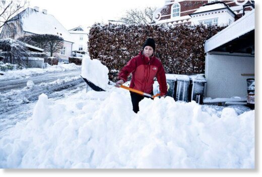 An Aalborg resident shovels snow from her driveway on December 2nd