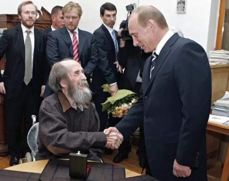 Solzhenitsyn shakes hands with Putin in 2007.