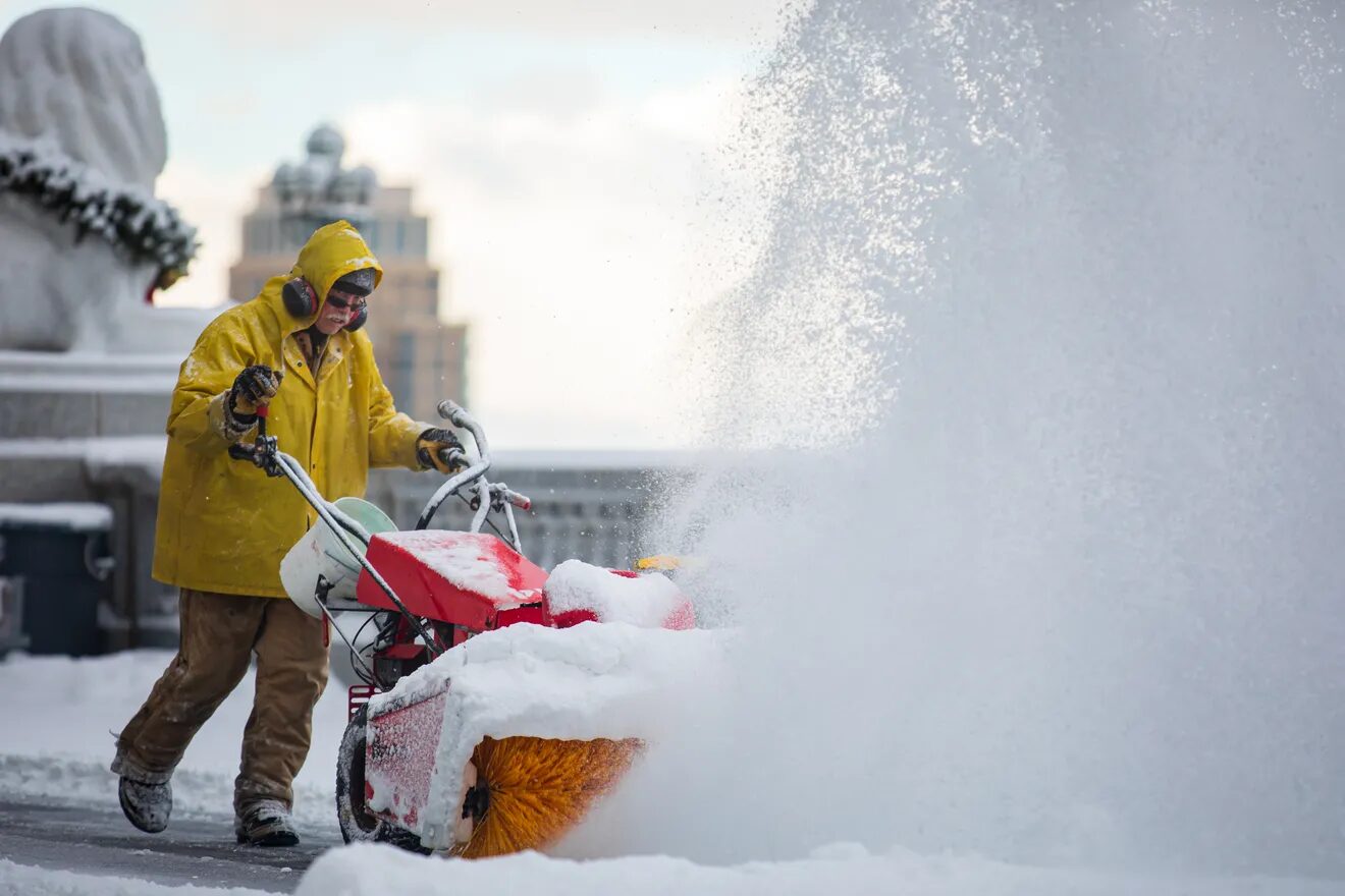Workers clear snow at the Utah Capitol on Friday, Dec. 10, 2021