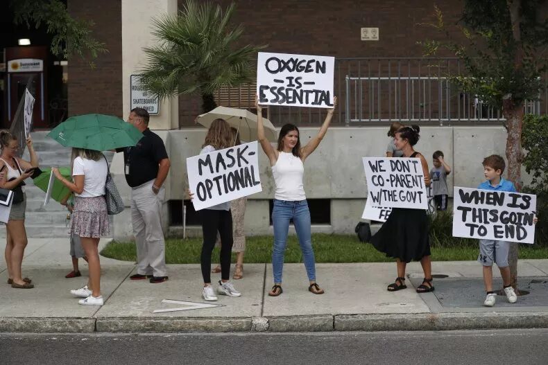 Click to enlarge Families protest mask mandates