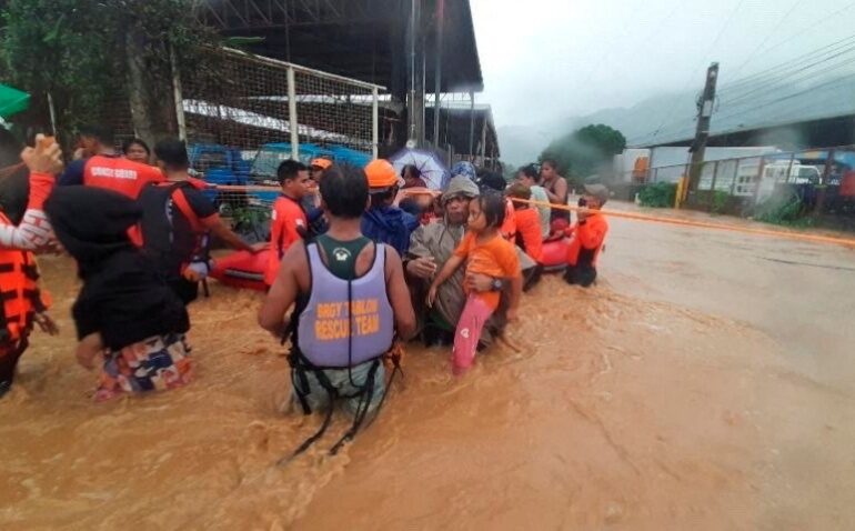 Philippine Coast Guard personnel assist in the evacuation of residents due to flooding caused by Typhoon Rai in Cagayan De Oro City, Philippines, December 16,