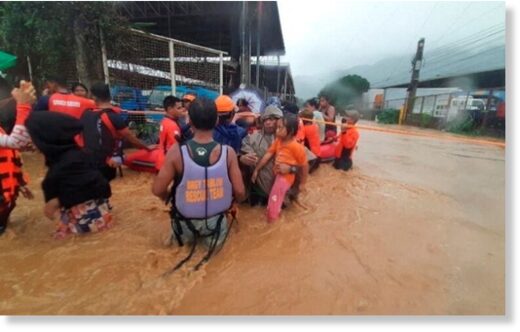 Philippine Coast Guard personnel assist in the evacuation of residents due to flooding caused by Typhoon Rai in Cagayan De Oro City, Philippines, December 16,