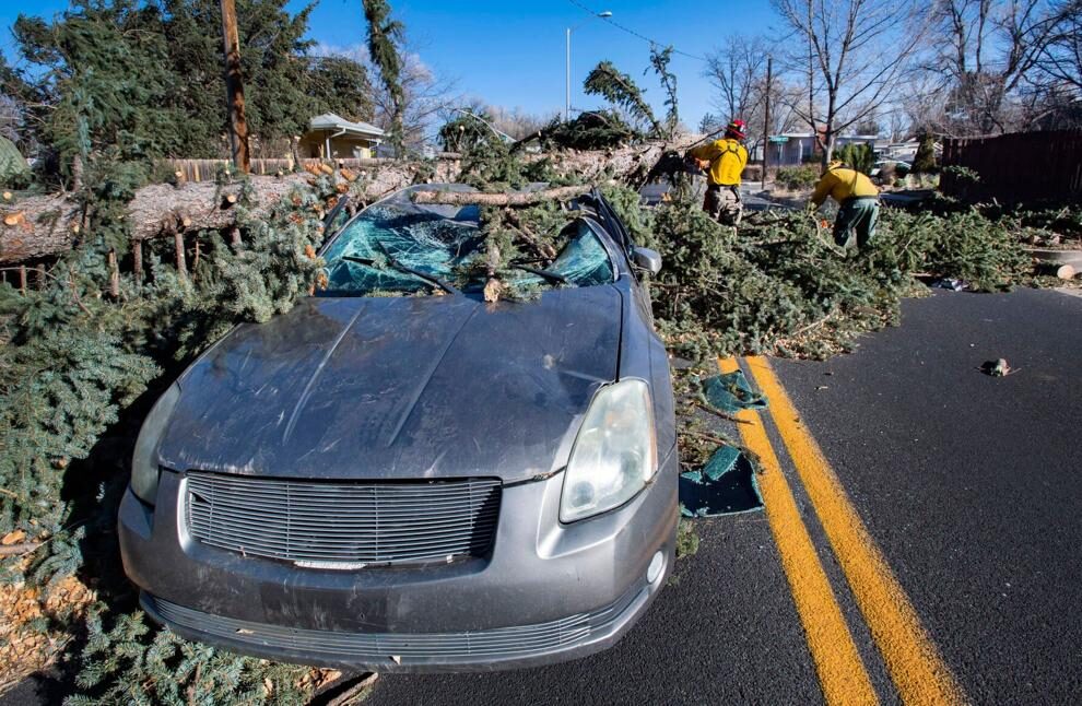 hurricane winds midwest US car crushed tree