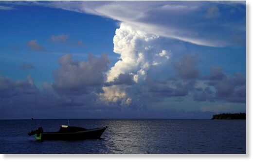 This picture taken on December 21, 2021 shows white gaseous clouds rising from the Hunga Ha'apai eruption seen from the Patangata coastline near Tongan capital Nuku'alofa.