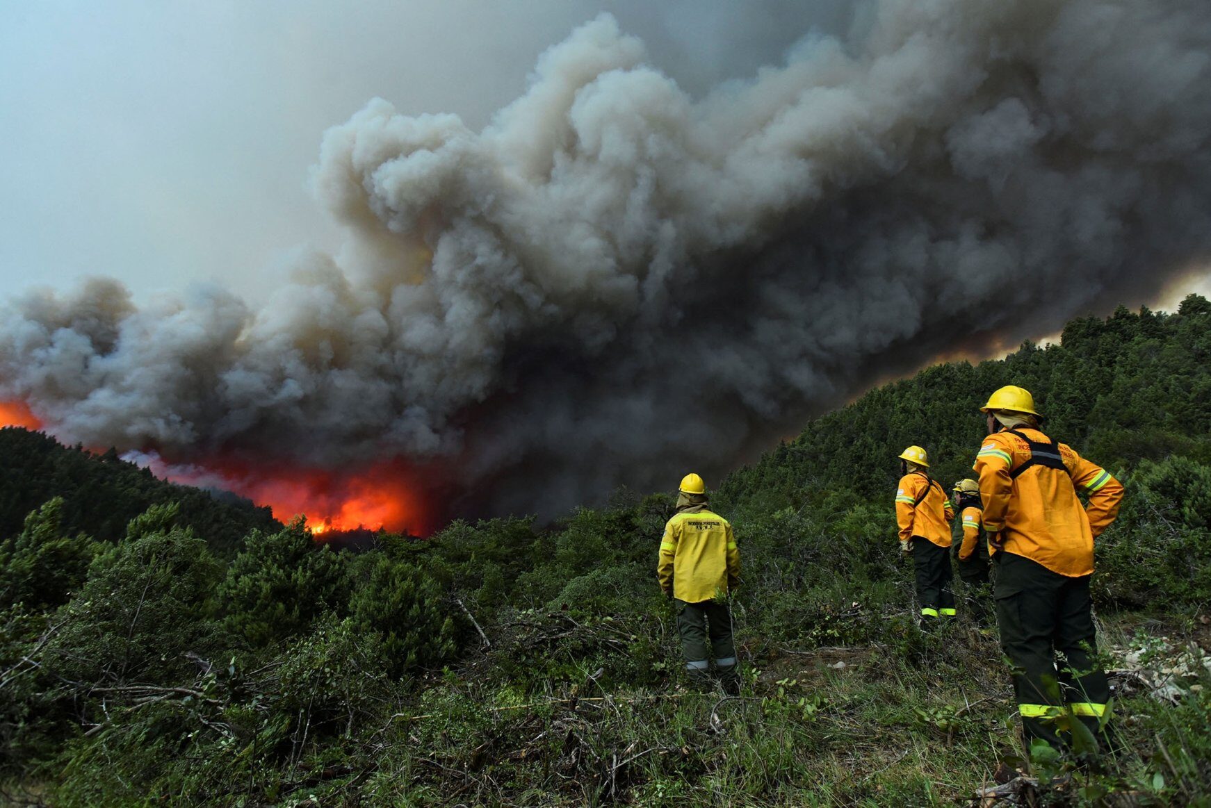 Click to enlarge Fire brigades monitor the forest during fires in Bariloche, Argentina, Dec. 29, 2021.