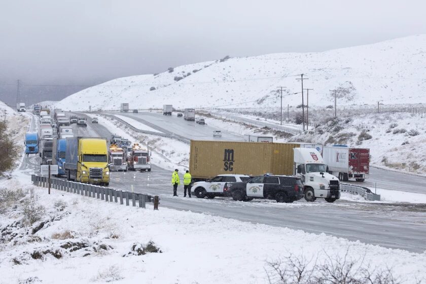 Traffic is turned around on the northbound 5 Freeway just before Gorman as a cold storm brought snow to parts of the Southland and closed the freeway through the Grapevine.