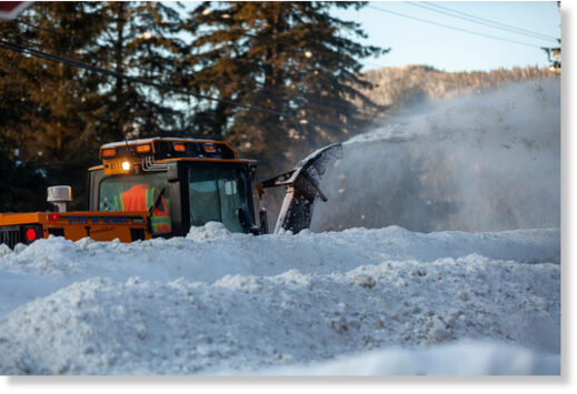 A state Department of Transportation worker clears snow from the sidewalk along the Glacier Highway in Lemon Creek on Tuesday, Jan. 4 in Juneau.