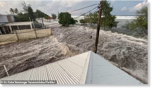 Click to enlarge A tsunami has struck Tonga sending terrified locals fleeing for high ground as huge waves crashed over roads and into homes (pictured, tsunami waves begin to overwhelm coastal homes in Tonga on Saturday)