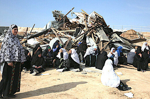 Palestinians and destroyed home