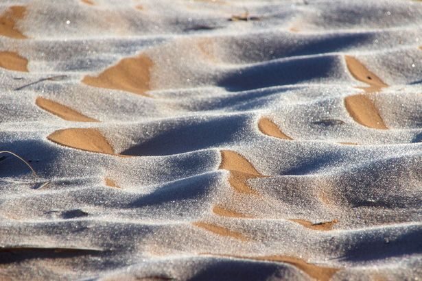 The ice created stunning patterns in the sand