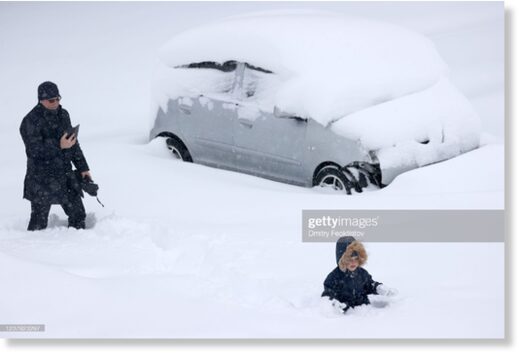 A child plays in deep snow in the city of Krasnodar, southwest Russia during a snowstorm.