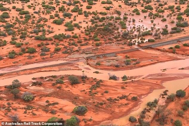 Some areas received up to 150mm of rain - or more than half their annual average in just a day or two. Pictured: The Stuart Highway impacted by floods