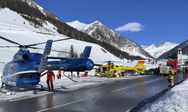 Rescue helicopters stand on a street near the Gammerspitze summit in Tirol after an avalanche killed a 58-year-old local man.