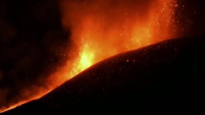 Impressive columns of red lava that jump into the sky from the huge crater of the Etna volcano, on the Italian island of Sicily.