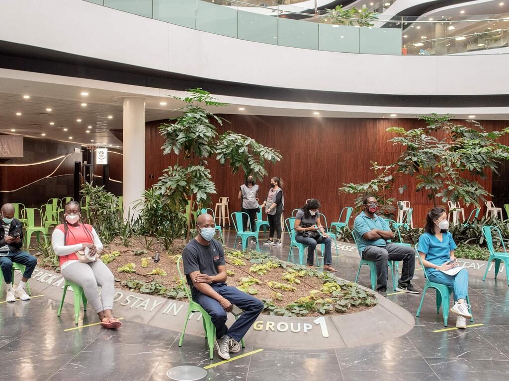 Click to enlarge People wait to be vaccinated in Sandton, Johannesburg