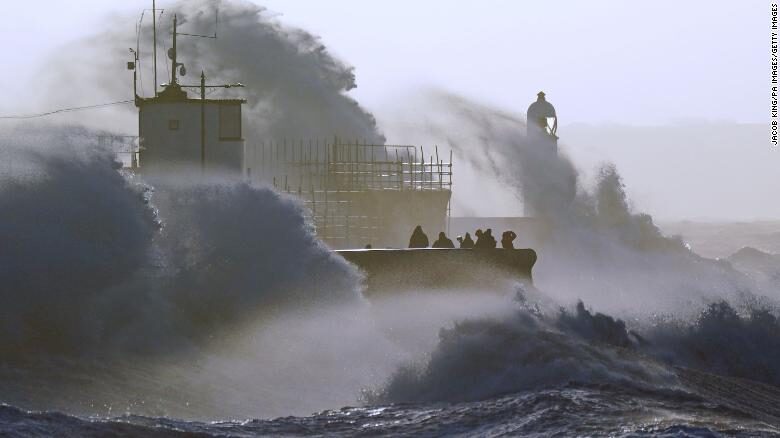 Click to enlarge Waves crash against the sea wall and Porthcawl Lighthouse in Bridgend, Wales, as Storm Eunice hits the UK on Friday.
