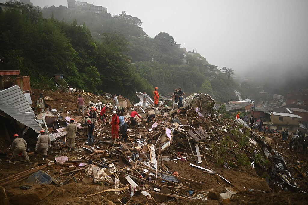 Residents and rescue workers clear debris looking for victims after deadly landslides in Petropolis, Brazil, February 18, 2022.