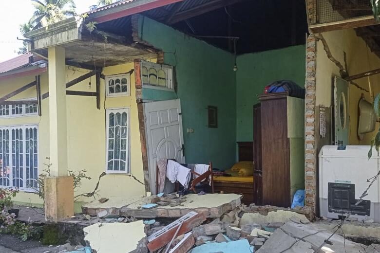 Click to enlarge Debris is seen outside a damaged house in Pasaman, West Sumatra, after a 6.2-magnitude earthquake struck the area on Feb 25, 2022.