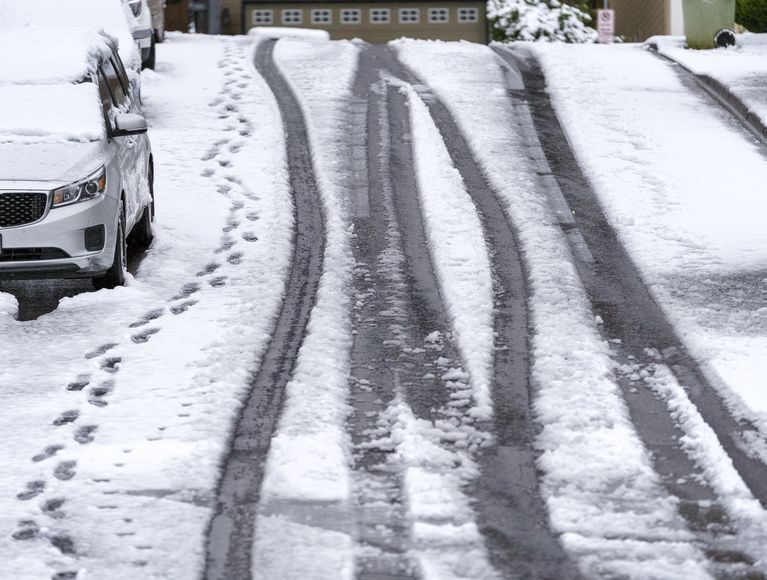 A few tire tracks and footprints lead down a hill in the Bethany area, April 11, 2022.