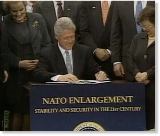 Bill Clinton signs NATO expansion legislation in May 1998.
