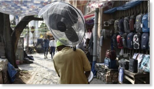 A man carries a fan during a heat wave in Kolkata, India.