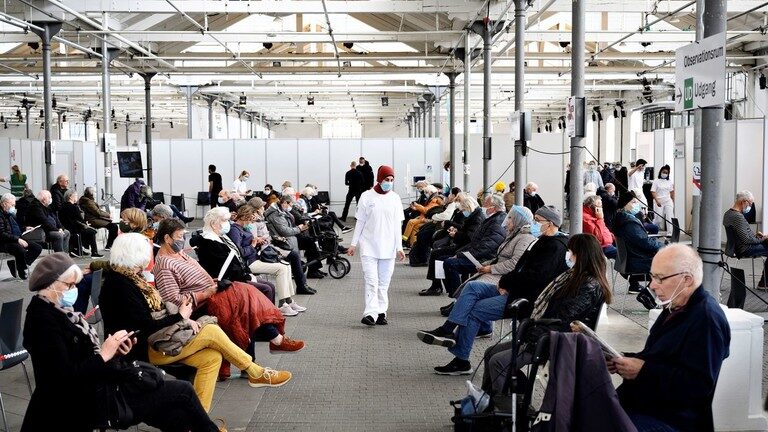Click to enlarge People wait in an observation room after receiving vaccine doses in Copenhagen, Denmark