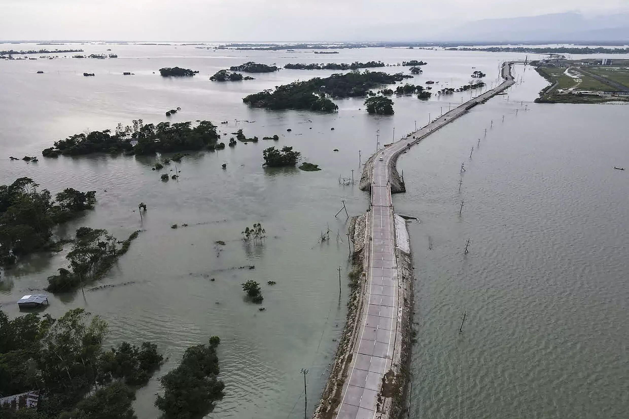 Floodwater breached a major embankment in Bangladesh's Sylhet region, affecting around two million people, swamping dozens of villages and killing at least 10
